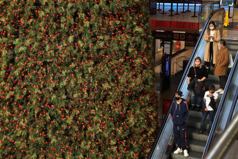 Shoppers walk through the Eaton Centre in Toronto on November 20. Retail will be allowed to operate for curbside pick-up or delivery only under lockdown rules that take effect Monday. Steve Russell/Toronto Star/Getty Images
