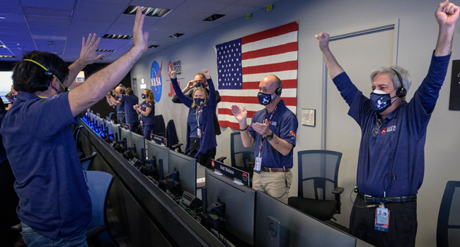 This NASA photo shows members of NASA’s Perseverance rover team as they react in mission control after receiving confirmation the spacecraft successfully touched down on Mars, on February 18, 2021, at NASA’s Jet Propulsion Laboratory in Pasadena, California. Bill INGALLS / NASA / AFP